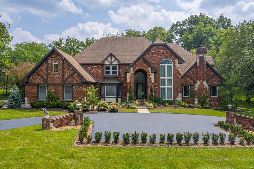 An impressive brick, stone & cedar elevation highlights the remarkable curb appeal of this spectacular 1.5-sty Estate home. Dramatic 2-sty arched porch entrance leads to marble foyer, formal living room with spiral staircase & stained glass window, elegant dining room with wide bay window & stunning great room with wet bar & brick fireplace. Spacious open kitchen with granite countertops, commercial grade appliances & 7’ center island adjoins breakfast room with convenient planning center & light-filled sunroom. Master bedroom suite radiates warmth with a marble fireplace, 3 walk-in closets, luxury bath with jetted tub & adjacent study with custom built-ins. T-staircase accesses 4 additional bedrooms, 2 with ensuite baths & 2 with Jack n’ Jill bath, & bonus room. Lower Level includes recreation room with wet bar, game room & family room with 3rd fireplace plus workout room, office, 2nd kitchen & full bath. Situated on parklike 1-ac grounds with patio, resort style pool & 4-car garage.