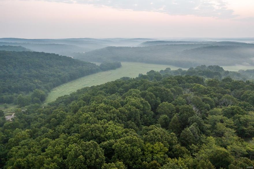 Multi-purpose 612+/- acre farm located in Pulaski County, Missouri. It is a farming and outdoorsman’s
dream with blacktop road access from Hwy. NN and many access points off of Springfield County Road. Large
blocks of mature timber surround its rich 100 +/- acres of hay producing/tillable ground that sit along Roubidoux Creek.
An additional 30+ acres of open ground set up for ultimate food plot scenarios, surrounded by great bedding and creeks
that run through the property to the Roubidoux basin. Over one mile of Roubidoux Creek runs through this property with three other tributaries, providing great water sources most of the year for cattle and wildlife. There are 6 ponds on the property, a cattle waterer, and multiple wet weather springs. With no exaggeration this property is also home to a very large cave. There is no doubt that the property is home to many trophy whitetails and turkey. Just minutes from I-44, this land is ready for farming, hunting and your dream home.