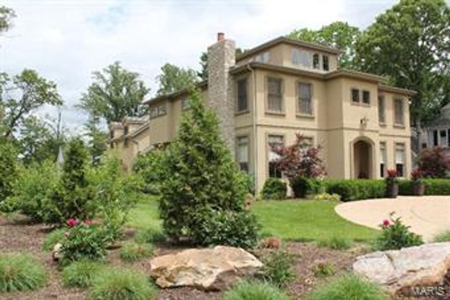 Stunning,newer 2.5 story custom home walking distance to downtown Kirkwood. Circle drive leads into spacious entry hall w/ travertine tile, fabulous dining room w/stone fireplace, butler pantry & floor to ceiling windows. Living room w/transom windows opens to hall & library areas w/built in bookcases. Chef's kitchen perfect for entertaining w/center island, custom cabinets, Viking & Dacor appliances, 2 Bosch dishwashers. Kitchen opens to family room w/stone fireplace, box bay ceilings, windows & French doors to gorgeous patio w/stained concrete & private yard w/sports court. Ten-foot ceilings & beautiful walnut floors & stained alder doors throughout home. Spacious laundry room, office plus two ½ baths complete main level. Upstairs: generous, light filled master suite w/large walk in closet, 3 more bedrooms & 2 full baths. Finished lower level w/deep pour w/rec room & exercise space. Lovely guest suite/mother in law qtrs. w/ full bath over 3 car garage.