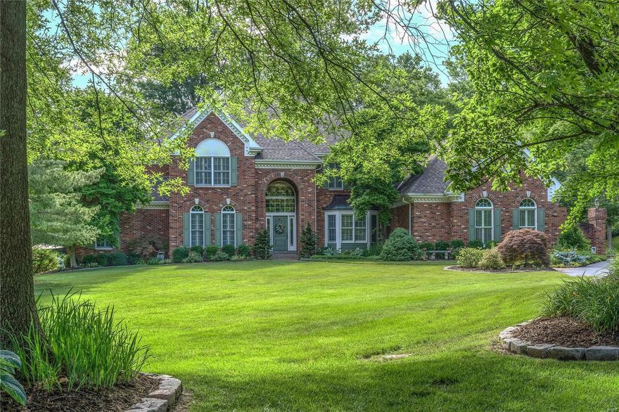 Classic-styled brick 1.5 Sty on park like 1+ acre grounds! Over 6400 sf of living space enhanced by superb craftsmanship & custom amenities throughout. Elegant 2-sty foyer opens to formal living room, sophisticated dining room with tray ceiling & spectacular great room with 2-sty bay window, floor-to-ceiling stone fireplace & wet bar. Designer kitchen with glazed cherry cabinetry, granite countertops & commercial grade appliances adjoins sunlit breakfast room with stone fireplace & butler’s pantry. The master bedroom suite offers a relaxing retreat with beautifully appointed marble bath with Jacuzzi, shower spa & morning bar and private deck. The 2nd floor extends the living quarters with 4 generous-sized additional bedrooms with Jack n’ Jill baths. Walk-out Lower Level features recreation room with fireplace, dining area, wet bar, guest suite & 2nd laundry. Outdoor living area includes heated pool with spa surrounded by landscaped gardens plus pavilion, 2 decks & patio with fire pit.