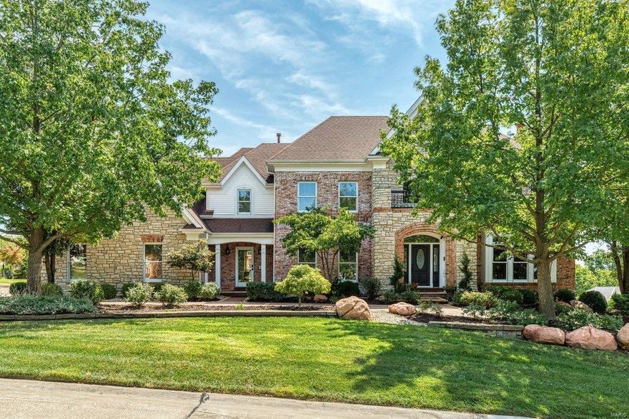 Spectacular 2-sty Homearama showcase home in prestigious Camelot. Impressive 2-sty hardwood foyer leads to library-paneled study with built-in bookcases & marble fireplace, elegant dining room & stunning great room with cast stone fireplace, wet bar & dramatic wall of windows. Designer kitchen with 42” glazed bisque cabinetry, granite countertops, premium appliances & double islands adjoins breakfast room with built-in breakfront & vaulted hearth room with floor-to-ceiling stacked stone fireplace. Front & rear staircases access coffered master bedroom suite with beautifully appointed bath, 3 additional bedrooms, 1 with ensuite bath & 2 with Jack n’ Jill bath, & bonus loft room. Lower Level entertainment space includes recreation room with 4th fireplace & wet bar, media room, office, workout room & full bath. Atrium doors open to outdoor living area with resort style pool & hot tub surrounded by landscaped gardens plus deck, covered patio with grilling station, fire pit & putting green.