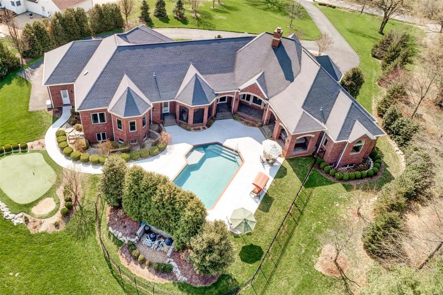 Luxurious brick and stone ranch home perfect for all your entertaining. The homes veranda wraps around the home & from every room you have views of your almost 2 acre estate, gorgeous lot, pool, waterfall, landscaping galore, & putting green. This Custom built home that has fantastic space w/ over 6300 sq ft in living space, 4 beds, 4.5 baths, 4 car garage, & mother-in-laws quarters in the lower level w/ separate family room, bedroom and bath. Master bedroom suite with sitting room. A stunning home that boasts a gorgeous entryway with circle drive, solid custom Mahogany front door, great room with gas fireplace, office with custom wood working, gourmet Kitchen with custom cabinetry and granite countertops. Lower level is the perfect entertainment center with exercise room, bar area, media room/family room, billiards room, and game room. All of this within 20 minutes of downtown and your favorite baseball team. This seller has spared no expense with the details and quality in this home.