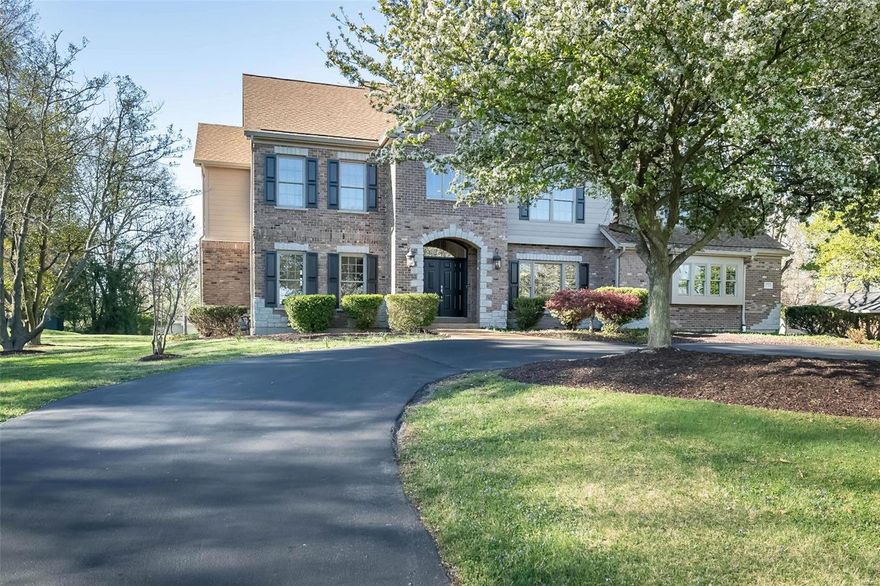 Curb appeal & so much more! 4900+ sq ft. Circle drive, open floor plan, 9’ ceilings 1st & 2nd flrs, abundant archways & beautiful wood floors. Acre + level lot. Gracious 2 story entry w decorator ledges, lovely inlaid wood floor, T-stairs. LR or office leads to FR w built-in cabinetry, gas fpl, window wall w transoms overlook expansive rear yard. Chef’s delight kitchen w lg center island, granite counters, stainless appl, Bosch dbl oven & dishwasher, 5 burner gas cooktop, micro ’24, frig ’22. Brk Rm & spacious Hearth Rm w tall cathedral ceiling & gas fpl lead to lg aggregate patio. Spacious dbl door owner suite w cathedral ceiling, 2 lg custom walk-in closets & luxury bath. Guest suite w bath, 3 additional bdrms – lg dbl door one could be bonus rm, compartmentalized bath w dbl bowl vanity w granite top & laundry rm complete 2nd flr. Abundant recessed cans. Move-in ready neutral décor. Deep pour LL w full bath. 3 car garage. Convenient to hospitals, restaurants, shopping, park, highways