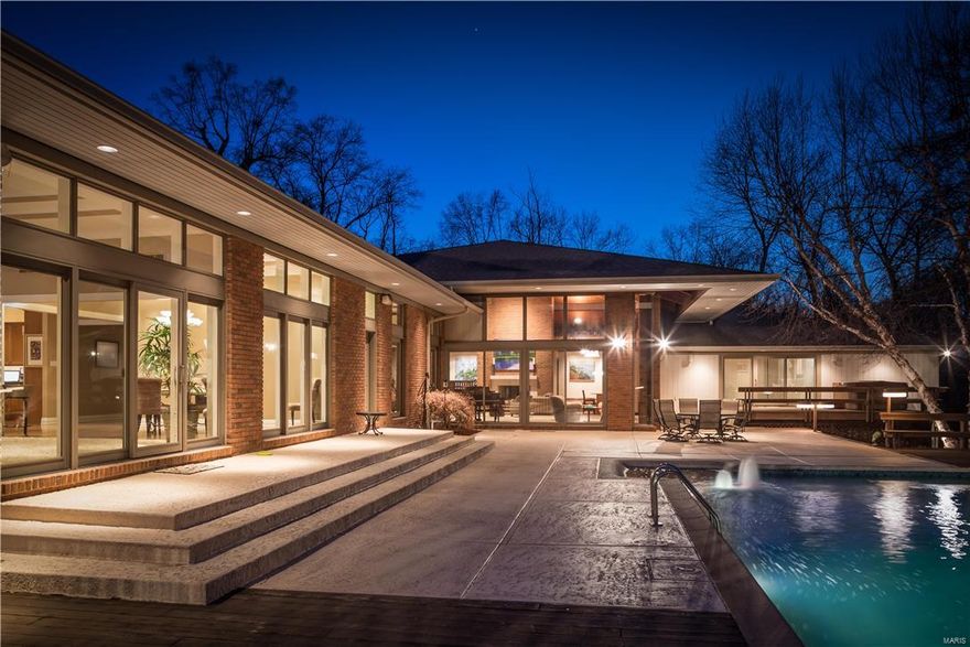 An extra ordinary opportunity to "Love Where You Live!"  This exceptional contemporary is worthy of Architectural Digest. And is featuring a Fresh New Look! This picture perfect home is meant to entertain both inside and out with its" Vacation-Like" lifestyle which is hard to find.  Remodeled and added onto in 2000 this home boasts custom features that enhance the perfect floor plan and design.  Dramatic vaulted Great Rm is the "highlight" of the home with walls of windows overlooking pool and private lot   6 bedrooms including private master suite / sitting rm and spa-like bath with views of pool and lot.  6 full baths and 3 half baths.  Multiple fireplaces, warm hardwoods, chef's kitchen, and open hearth room area.  Oversized laundry-utility room with built-ins and bath opens to huge 4 car garage.  Breathtaking views of this forested 3 acre residence with pool and tennis court revel in this relaxing atmosphere.