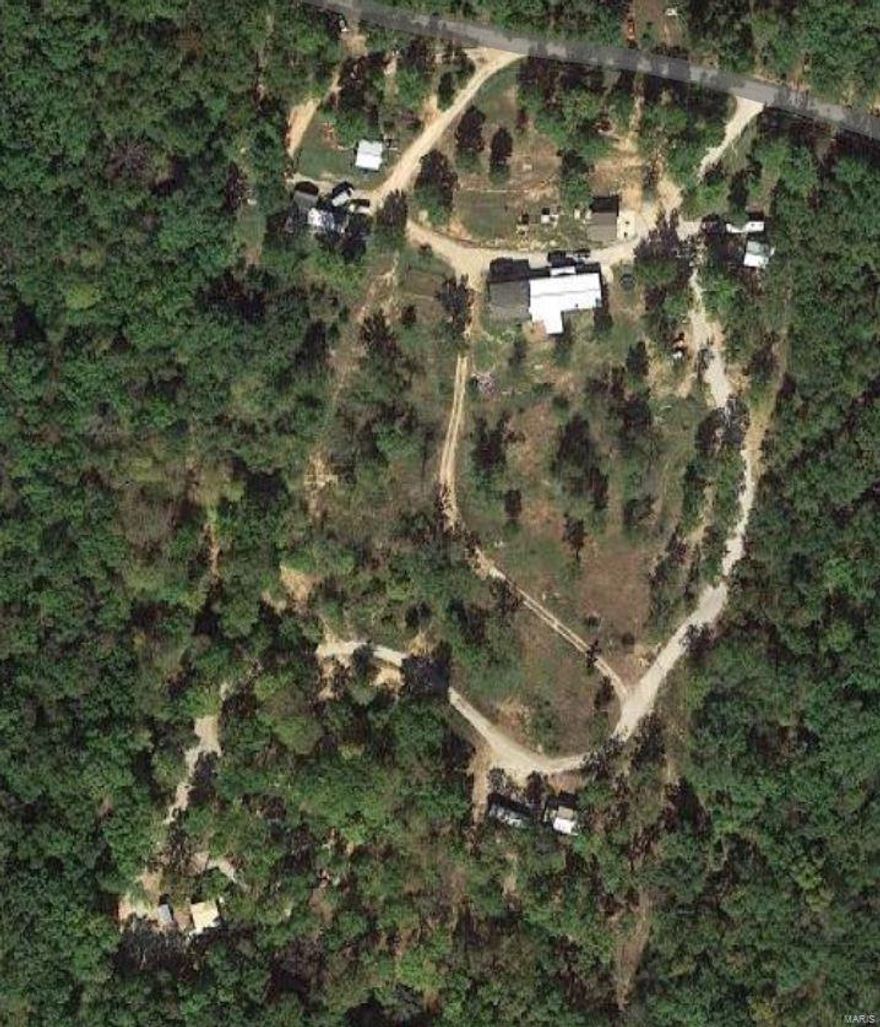 Come check out this Awesome 10 Acre property with MANY possibilities!  Lots of beautiful views where you can enjoy your very own Caves! You can also stock your own fishing pond! Properties main house is a nice 3,812 Sq.Ft. home.  Relax and soak your cares away in the huge Hot Tub Room with fireplace, & private bar. Additionally there is a new foundation for additional house, w/roughed in plumbing. It has a very nice patio & walkways. There is another home that could be an Air B&B, mother in-law quarter, or income rental! (Inside needs finishing.) It has a lovely deck as well.  There are 4 additional metal buildings included. One has 2 car garage w/two additional rooms & lovely deck! Lots of room in this building! This property would be great for growing crops due to direction of Sun! There are 6 watering spickets on property & two fuel tanks for Gas and Diesel for equipment. There is a small Chicken Coop too. Possibility endless! Schedule your appointment before this one gets away!