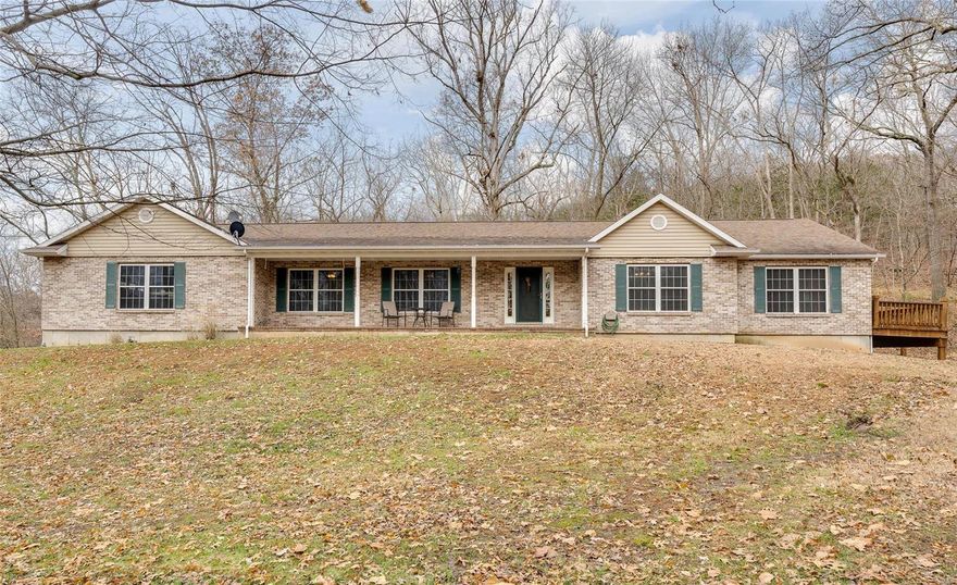 This home has been perfectly crafted for anyone seeking peaceful and private country living while still being close to a range of modern conveniences and city amenities. You will love living on more than three acres of picturesque land with a spacious horse pasture backing onto Greensfelder Park. The open floorplan features vaulted ceilings and an abundance of windows that draw in natural light and perfectly frame the forested outlook. The eat-in kitchen has a center island and modern stainless steel appliances while the spacious living room features a cozy fireplace and is open to the dining room. Those who love to entertain will adore the large sun-soaked rear deck or the nearby patio with a pergola. Completing this home is a walk-out lower level and an oversized three-car garage. Hundreds of acres of land are waiting to be explored within the Greensfelder Park while only minutes away from the city amenities.