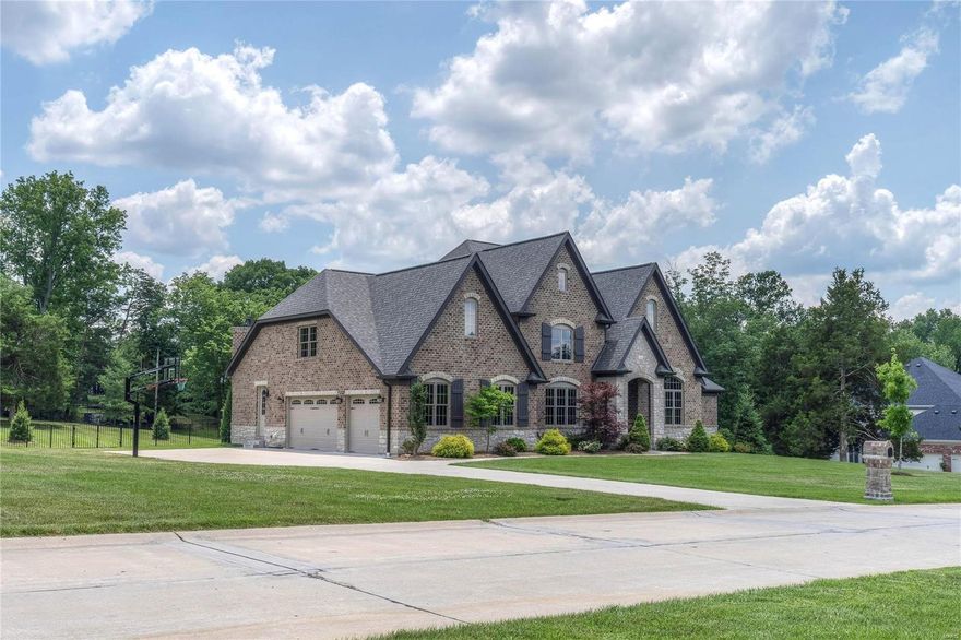 This 1.5-sty Estate home redefines luxury living! Over 6600 sf of living space w/ soaring ceilings, elaborate millwork & wide plank flooring on the main floor. Extraordinary 8’ wrought iron double doors lead to grand 2-sty foyer, paneled study w/ vaulted ceiling, elegant dining rm & stunning great rm w/ fireplace with cast stone mantle & dramatic wall of windows. State-of-the-art kitchen with 42” white cabinetry, granite countertops, Thermador appliances, 9’x7’ center island with walnut butcher block top & butler’s pantry adjoins breakfast room w/ bay window & hearth room highlighted by floor-to-ceiling stone fireplace. Coffered master bedroom has 2 walk-in closets & marble bath. Hardwood staircase accesses 3 bedrooms, 1 with ensuite bath & 2 with Jack n’ Jill bath & a raised media room. Walk-out LL has rec room, billiard room w/ stone fireplace, 2nd kitchen, office, 5th bedroom & full bath. Professionally landscaped 1.66 ac grounds with award winning designed pool & 3-car garage.
