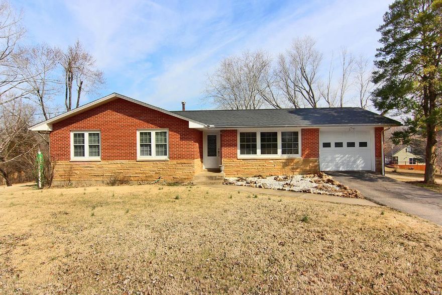 Situated on a .62-acre lot on a quiet country corner just outside Marble Hill City limits this ranch-styled, 1,756 sq ft home is smoke-free with a low maintenance exterior of red brick and stone with white siding on the back wing This house has three bedrooms and 2 full baths, a living room, a nice size kitchen and dining area with a walk out on to a 14 ft X 14 ft deck. It has a dishwasher, sink-disposal unit, and a gas range along with all Oak Cabinets.  Off to its side there is a private den/office area with a separate walk-up entrance which contains one of the 2 full baths. The den also has access to the deck and a side porch.  It features a partially finished, full-sized basement with a walk-up to the outside. The basement contains a small tool-room and storm shelter area currently being used as a food storage room with built in shelving, a finished office area, laundry hook-ups, deep freezer chest and a large unfinished area containing three small windows.