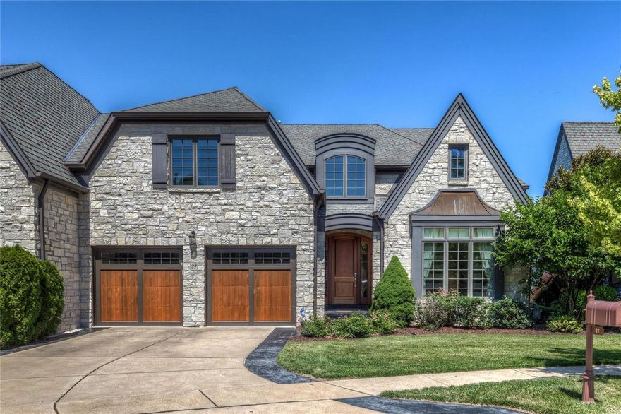 Absolutely stunning in every way.  This beautiful attached villa is located in a private gated community in the heart of chesterfield. Situated in on a private lot, backing to mature trees.  Outstanding curb appeal with four sidded stone exteiror, custom garage doors and beautiful front door. To the rear, are double stacked screened porches over looking a private rear yard with mature trees.  Very elegant interior with large formal dining, open custom kitchen with granite counters, center island, gas cook top, to family room and first floor office.  Wood flooring, fireplace, 9 foot ceilings.  The 1st floor master is lovely with a large master bath with dual vanities, whirlpool tub and separate shower.  Large customized master closet as well.  Upstairs there are two bedrooms each with their own bath, and a family room area.  The Walk out  Lower level is finished with another large family room, custom bar, fireplace, wine cellar, media room, work out room, bedroom and full bath.