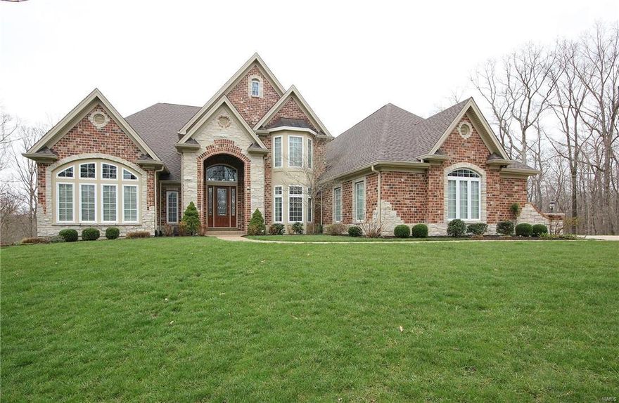 Fantastic 1.5 story nestled on 3 beautiful wooded acres. Custom front door. Magnificent 2 story entry foyer with curved staircase, & balcony. Den/Office with window wall. Dining room with tray ceiling. Butler pantry. 2 sty great room with floor to ceiling circular bay, fireplace & built ins. Gourmet kitchen with custom appliances, granite, breakfast bar & walk in pantry. Breakfast room with bay window. Vaulted hearth room with floor to ceiling stone fireplace opens to a covered deck & an open deck. There is a side porch that enters a family foyer that opens to the garage, laundry, kitchen, and a second stairwell to the upstairs. Finished lower level with huge family room, rec room, and a 3rd fireplace. Temp controlled wine room with 400 bottle racks. Custom bar complete with TV, ice maker, beer cooler, wine chiller, dishwasher & refrigerator. Exercise room, bath & walkout complete the lower level. 3 big bedrooms & 2 baths up. 3 zone HVAC. Wired by the sound room.