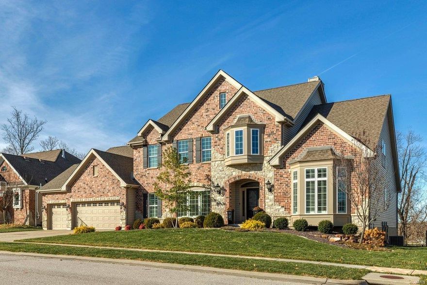 Beautifully designed brick & stone 1.5 Sty from DH Custom Homes. 2-Sty hardwood foyer highlighted by dramatic flared staircase leads to private study with French doors, elegant dining room framed by arched entryways & stunning great room with granite bar, marble fireplace flanked by built-in bookcases & wall of windows with private wooded views. Spacious open kitchen featuring granite countertops, staggered cabinetry, 11’ center island & butler’s pantry adjoins breakfast room that opens to deck & hearth room with stone fireplace & convenient planning center. Coffered master bedroom suite with luxury bath offers an appealing retreat. The 2nd floor extends the living quarters with 3 additional bedrooms, 1 with ensuite bath & 2 with Jack n’ Jill bath, & bonus room. Lower Level includes recreation room with quartz bar, game room, family room & 1/2 bath. Premium cul-de-sac lot with covered patio & paver stone patio with firepit. Dardenne Greenway is just a short walk or bike ride away.