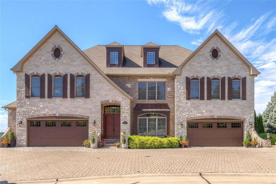 Spectacular brick & stone Estate home in prestigious Tapawingo On The Green! Over 9400 sq ft of living space with soaring ceilings, extensive millwork & walls of windows with unsurpassed views of the golf course & Meramec River valley. Dramatic 2-sty foyer leads to formal living & dining rooms and great room highlighted by stacked stone fireplace. Exceptionally large kitchen features 42” cabinetry, granite countertops, professional quality appliances, 9’ center island & butler’s pantry. A private study, adjacent library & sunroom complete the main floor living area. Front & rear staircases access vaulted master bedroom suite with morning bar & beautifully appointed bath with jetted tub & fireplace plus 3 generous-sized additional bedrooms, office & bonus/5th bedroom. Lower Level includes recreation room w/ fireplace, 2nd kitchen, workout/sun room, guest suite, 5th bedroom & full bath. Premium cul-de-sac lot w/ patio & pool surrounded by landscaped gardens and 2 oversized 2-car garages. Additional Rooms: Mud Room, Sun Room