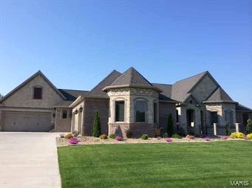 This new Tuscan Style Home features a detailed brick and stone exterior with 2 large covered porches and 2 attached garages with the capacity for 7 cars.  It has 5 bedrooms, each with its own full bathroom and walk-in closet!  The master suite has enormous his and her closets with custom built-in lighted cabinets and granite!  There are two custom vanities, an amazing tile shower with Bronze Brizo faucets, and Freestanding Air Elite Tub.  The tile detail in the master suite is beautiful!The main floor living area features a large granite fireplace, knotty alder paneling, hand finished walls, 7” wide quarter sawn oak, hand scraped hardwood floors and incredible twisted iron light fixtures.  The gourmet kitchen has beautiful Buessink custom cabinets with hand glazed finish, pull outs and full extension glides.  With large walk-in pantry, two kitchen sinks, two dishwashers, and two pull out trash cans, this home is ready for entertaining large groups!  Only the best appliances are in this