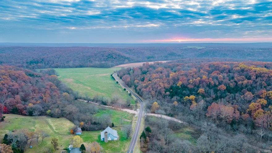 Multi-purpose 612+/- acre farm located in Pulaski County, Missouri. It is a farming and outdoorsman’s dream with blacktop road frontage. Large blocks of mature timber surround its rich 100 +/- acres of hay-producing/tillable ground that sit along over one mile of Roubidoux Creek frontage. An additional 30+ acres of open ground set up for ultimate food plot scenarios, surrounded by great bedding and creeks that run through the property to the Roubidoux basin. There are 7 ponds on the property, a cattle waterer, and multiple wet weather springs. With no exaggeration this property is also home to a very large cave.This amazing farm literally has it all; tremendous hunting, fishing, food plots, hay production, and potential for tillable farming or livestock, allowing for great opportunities for its new owners. A nice 1,400 square foot, 3 bedroom, 2 bath ranch also accommodates the property. Just minutes from I-44, this land is ready for farming, hunting and your dream home.