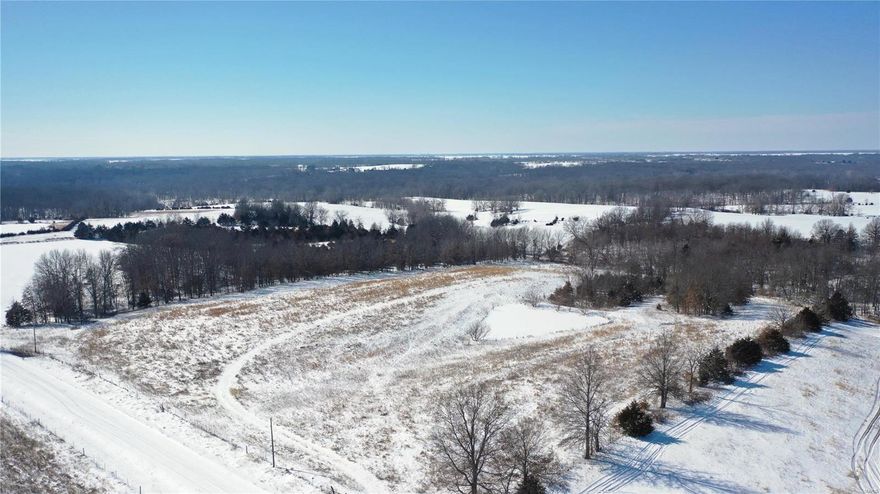 Located about 9 miles north of Clarence, Mo in Macon County on the Shelby-Macon county line this 12 +/-  acre building lot or cabin location is setup perfect and has a little bit of everything.
If you are looking for a beautiful building lot in the country this is it, all utilities are at the road including electric, water, and phone.  There are two nice building locations that overlook a nice .25 acre stocked pond.  Walking around the property I saw a bunch of rabbit tracks and the small wet weather creek on the west side will serve as a nice funnel for deer.  There is plenty of deer sign as well with a good amount of cover on the property and the surrounding properties.  With 8 acres in CRP the property is paying roughly $1200 dollars a year in income.
What a rare opportunity to find a property in this location with all the utilities needed to build your dream home or cabin and just enough acreage to go fishing or hunting.