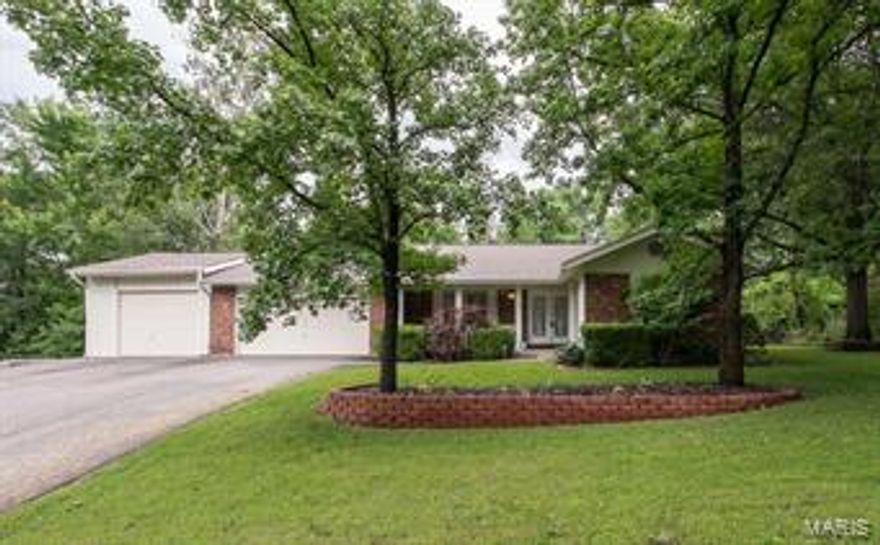 Updated, 3 BD, 2.5 BA, ranch home with an AMAZING oversized 3 car garage. The third stall offers not only added width and depth but an 8’ tall door and a rear entry garage door for accessibility to the back yard.  It is rare to find a home in this price range with a garage like this. Interior features inc new hardwood floors (2014) in the Living Rm-Dining Area-Kit-Hallways-Bath, Fireplace, white 2 panel doors, ceiling fans, update lighting, open stairs to the lower level, security system and more. The Kitchen has been updated (2014) and is fantastic w/Maple cabinets, soft close doors-drawers, roll out shelving, granite countertops, st steel appliances, glass backsplash and a garden window. There is excellent curb appeal w/a brick front, leaded glass dbl front door, architectural shingles (2013) and matures trees. The finished lower level adds app 537 S/F for a total living area of app 1,669 S/F. The location is great w/easy access to Hwy 94-364 & a short commute to both Hwys 70 & 40.