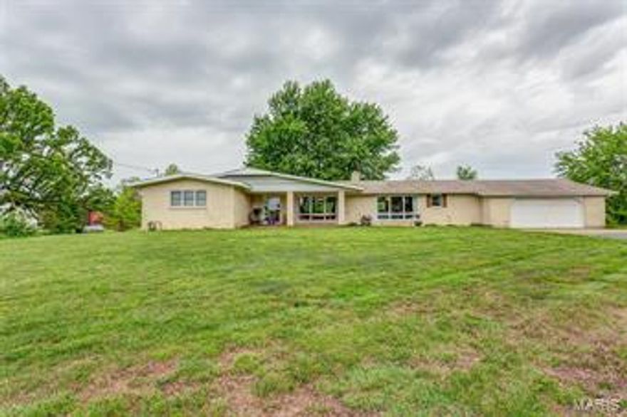 This beautiful brick home sits over a full basement and a two car garage with built in storage. Pulling up, you will notice the large yard and covered front porch- perfect for those early morning cups of coffee. The spacious living room is carpeted for comfort and offers tons of natural lighting and a gorgeous brick fireplace. The kitchen is massive and features an ample amount of cabinetry, gas stove, pantry, center island with a second sink and access to the covered back patio overlooking the large backyard with an above ground pool! The master bedroom provides it's own private master bathroom. There are 2 additional guest bedrooms, an office with a built in desk and another full guest bathroom. The lower level has been framed for three more bedrooms, a large storage area and has a wood-burning fireplace. This home has tons to offer! Call us today to schedule your private showing!