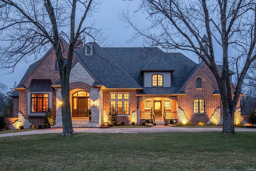 Beautifully designed French Country Estate home with over 8800 sf of living space enhanced by distinctive architectural elements & extensive updates throughout. Impressive octagonal foyer leads to paneled library with custom built-ins, formal dining room & stunning great room with wet bar, granite fireplace flanked by bookcases & French doors that open to veranda. Designer kitchen featuring glazed cabinetry, granite countertops, commercial grade appliances, planning center & butler’s pantry adjoins breakfast room with bay window & vaulted hearth room highlighted by floor-to-ceiling stone fireplace. Coffered master bedroom suite with marble bath with shower spa offers a relaxing retreat. The 2nd floor extends the living quarters with 3 additional bedrooms, 2 full baths & bonus room. Lower Level includes its own “Irish Pub,” family room with fireplace, media room & game room plus workout room, 2nd kitchen, guest suite & pool bath. Situated on 1+-ac grounds with pool & patio with firepit.