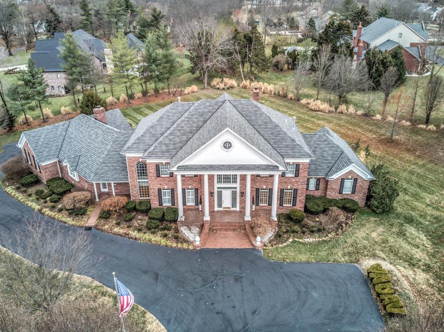 Magnificent residence in a quiet gated community. All brick construction. Built by Rehnquist. Level two-acre lot with mature trees, gardens, and fountains. Two story entry foyer with curved staircase. Two story great room with window wall and wet bar. Gourmet kitchen with center island, granite countertops, high-end appliances, and walk-in pantry. Luxury master suite with 10' coffered ceiling, two walk-in closets, vaulted bathroom, walk-in shower, soaking tub, and dual vanities. Hearth room with floor-to-ceiling brick fireplace. Finished lower level with office, gym, media room, sunken living room, game room, bathroom, cedar closet, sauna, wet bar, full kitchen, stone fireplace, and recessed lighting. Large main level laundry room. Nine foot second level ceilings. Four car garage with man door and private stairs to basement. Extensive mill-work. Central vacuum. Dual covered front porches. Large patio. Circle drive. Quick access to 40 and 270.