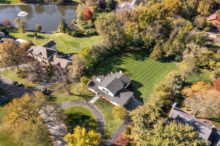 The modern black and white curb appeal sets the tone of what awaits inside this California-cool renovation! A stunning 2-sided fireplace separates the vaulted living and dining room with a wet bar. The kitchen/hearth room features custom cabinetry, Quartz countertop and backsplash, island seating, informal dining area, fireplace, and glass doors to the deck. Main floor Primary Suite with walk-in closet, double vanities, soaking tub, private water closet, and linen storage. The 1st floor is complete with an office (or bedroom), half bath, and laundry/mudroom. Upstairs are 3 bedrooms and a full bath with double sinks and pocket door divider. 1448sqft of finished space in the walk-out basement includes a sleeping room, full bath, and dry bar with beverage fridge. 3-car attached garage. Every inch of this home was touched with the highest level of finish and design, but the icing on the cake is the spectacular and private 1.113acre lot which truly feels like your own personal park! Additional Rooms: Mud Room