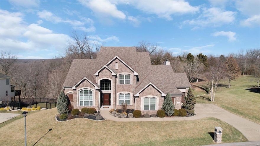 This exceptional Hardesty-built home in like-new condition sits atop the coveted Homestead Estates, offering the perfect blend of luxury and nature in a vibrant neighborhood setting. The expansive 1.5-story design includes 5 bedrooms, 4.5 baths, and exquisite upgrades throughout. Step inside to find a grand office, an elegant dining room with a coved ceiling, and a breathtaking great room with a wall of windows. The stunning kitchen, breakfast, and hearth rooms are a dream—featuring a center island, counter seating, Thermador appliances, a gas range with hood, a built-in fridge, and a beverage center, all complemented by solid hardwood floors. A professionally designed, highly efficient pantry, main floor laundry and a coat room add to the home's thoughtful layout. The main floor master suite is a true retreat, while three spacious bedrooms await upstairs and another in the finished lower level, complete with a covered patio and an elevated yard. A rare gem in a premier location! Additional Rooms: Mud Room