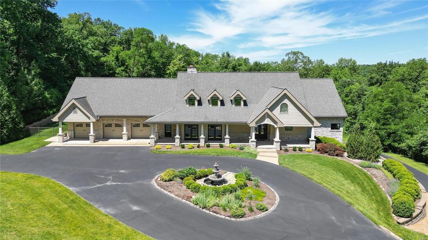 Welcome to this exquisite luxury property nestled in the heart of Sunset Hills. This custom-built masterpiece spans 2.65 acres, offering a perfect blend of privacy and stunning nature views. Designed with both comfort and entertainment in mind, this home features an impressive bar and billiards room adjacent to the main living area. This space seamlessly flows into a cozy hearth room and a grand custom kitchen. The kitchen is a chef’s dream, equipped with Viking appliances, a gas range with hood, three ovens, custom cabinetry, and a center island. From the kitchen, step outside to an inviting heated pool with a retractable cover, a sauna, and a hot tub. The outdoor area also boasts a phantom-screened porch with a wood-burning fireplace, creating an ideal setting for entertaining guests year-round. This luxurious home offers 4 bedroom suites, 8 bathrooms, 4 garages, and a finished walk-out basement that includes a gym, this property ensures ample space and amenities for all your needs.