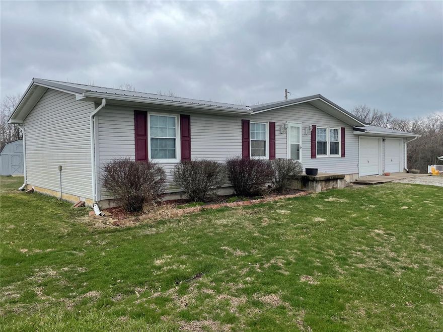 Everyone seems to be looking for a home just outside of town, with small acreage and on a hard surface road. Well look no further as this home has all the above. Located just .8 of a mile north of Perry on state hwy J. You will find this 3 bedroom home on 2.08 acres. Built in 1986 this home would make a great place to raise a family or would also make a great weekend get away. Owners have lived in the home since 2000 and have taken good care of the house and have upgraded over the years with siding, windows, and metal roof. They've also added a 16x12 deck overlooking the backyard, perfect for evening barbeques in the shade. Backyard is spacious with 2 garden sheds for storage. Still plenty of level building space in backyard for metal building or pole barn if wanted. Come see all this charming home has to offer. Call today to schedule your own private showing!