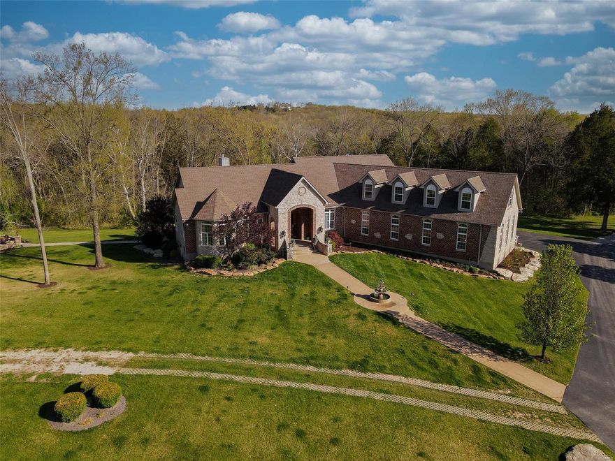 *GATED PRIVATE COUNTRY STATE*25 ACRES*2nd GUEST HOME*8500 SQFT* Private country estate on dead end road with trees & abundant wildlife yet less than 10 minutes from major retailers & interstate. Finished 5 car garage with 15 ft ceilings plus a separate 40x40 barn with heat & full bath. The amenities of this home are first class! The Master suite is astonishing & the bath is like a day at the spa! The basement features a full bar, built in gun safe, large entertainment area, separate dog grooming room, sauna, fitness room, is 100% smart-home enabled to include all lighting, speakers, bar & drop screen entertainment system & much more.  This estate also comes with a separate rehabbed 2-bed guest house. The horse stable has 5 stalls which include water, tack room & birthing stall. The land is absolutely the best the Midwest has to offer & features a 100+ ft waterfall, small pond with fountain, acres of gently rolling hill & trees, basketball court, shooting range & pond with a clubhouse. Suitable for Bed/Brk Additional Rooms: Mud Room