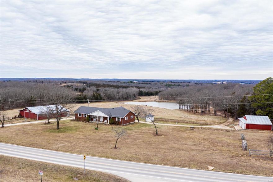 Here is a fresh canvas to make this 3 bedroom 2 bath ranch your own. There is a limited supply for property such as this desirable 25.44 ACRES with 2.5 acre STOCKED LAKE, detached 3 car garage, with work shop space, approx 60x52 COW BARN, with 2x4 rough cut wood, stalls, loft, has water & equipment storage. There is also a smoke house & chicken coop. Endless beautiful sunsets available from the suspended concrete covered patio. Quality, owner/contractor built ranch offers 1296 sq ft on the main floor that is ready for you to finish to your own tastes. 2 car garage, full walk out basement, partially finished with a sleeping area, family room, 2nd kitchen/dining area & an additional multiple use work space with concrete ceiling, plumbed for water & walk out to back patio. This gorgeous property also has a cabin by the lake with its own well, property is mostly fenced, so bring cattle, horses, & other livestock. One of a kind, opportunity, located in a great location, black top roads.