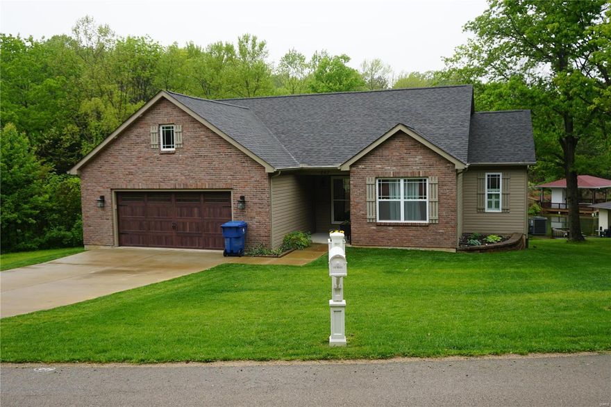 Immaculate 4 bdrm, 3 full bath ranch sits waterfront on Lac Carmel! Only 3 years old! Vaulted great room has hardwood floors, 5" base trim & electric fplc. Kitchen has upgraded cabinets, solid surface tops, crown mold, four stainless appliances, subway tile, under cabinet lighting & ceramic tile. Divided bdrm floor plan, 3 bdrms on main floor. Master bdrm features coffered ceiling, walk in closet & full bathroom w/ stand up shower. Levelor curtains. MF laundry. Covered cedar deck w/ black balusters & ceiling fans. 2 car attached garage. Finished LL has bedroom, full bath, and rec room. Walk out to covered patio & level yard. Lakeside features boat slip w/ ladder. Electric awning attached. French door out utility room for easy parking of golf cart. Water filtration system installed. LeafFilter gutter guard has lifetime transferrable warranty. Beautiful landscaping. Lots of storage space. Terre du Lac, private lake community hour south of St. Louis 16 lakes, fish, boat, swim, golf, CC.