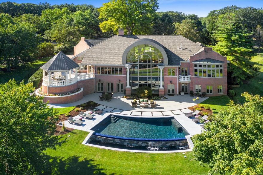 Resort style living with priceless views! The lush landscaping, refinished circle drive and a gorgeous fountain greet you upon arrival! As you enter the home the great room will wow you with floor to ceiling wall of windows with panoramic golf course views! Situated on over an acre in Ladue schools, you can truly enjoy the outdoors with the brand new infinity edge pool, patio, gazebo and newly built in BBQ Grill. Featuring over 7300 square feet of living area with marble floors, artisan millwork and expansive rooms. The luxe main floor master wing includes an enormous bedroom, his and her custom closets, luxe bath and an abundance of storage. The kitchen is equipped with new appliances, island seating, eat in kitchen, hearth room and a custom built in office space adjacent to the kitchen. The expansive lower level walks out to the pool features 3 additional bedrooms, 2 full baths, two new sub zero wine refrigerators and rec room!  Resort living for today's lifestyle! See virtual Tour!