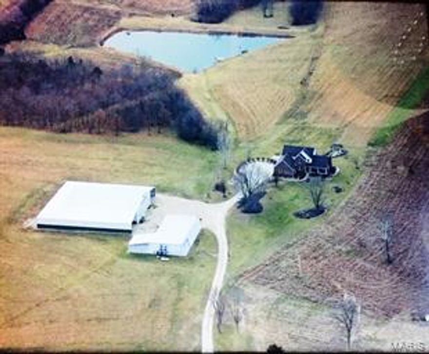 Absolutely stunning views from every angle on this hilltop New Haven farm of rolling pastures and cropland with incredible newer 3100 sq. ft. home.  8-10 minutes to Washington or New Haven with several outbuildings to live your dreams out in.  Postcard perfect scenery! Tucked off the main road too! This land is all rolling hills with 360 panoramic views all around. Geo thermal and solar . 3 fireplaces. Screened porch overlooking lake and countryside. 2 decks, patio too. Maintenance free home with stunning wood detail, gorgeous  kitchen with solid surface counters, center island, gas cooktop, double ovens, three seasons room and massive deck to enjoy the views from.  Nice size main floor laundry room with built-ins for extra storage. Huge pantry. Partially finished walk-out lower level boasts a family room/rec room with fireplace and granite top bar ,extra sleeping area.   This property has three tax ID's with a total of 112.4 acres. Intricate woodwork thru home showing craftsmanship.