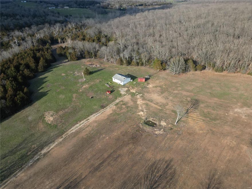 BACK ON THE MARKET, NO FAULT OF SELLER. Tons of Potential! This beautiful property includes 114.5 +/- acres at the corner of U Hwy and KK highway. Roughly 5%  is fenced. Additionally there is pasture land, and the rest of the land is mostly wooded. Sale includes a 3 bed 2 bath fixer- upper house House to be sold as-is. This property will not last!