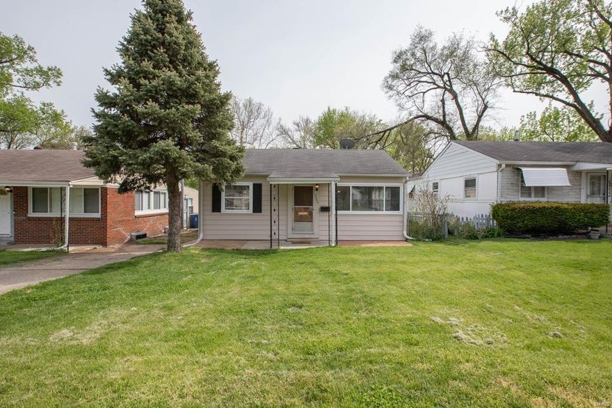 Spectacular 2 Bed Bungalow with newly refinished hardwood flooring! Charming front porch opens to inviting light-filled Living Room with hardwood floors that flows into the hallway and both Bedrooms, plus large windows that fill the room with natural lighting! Kitchen offers custom cabinetry, low-maintenance countertops, and open views of the Dining Room which features 3 walls of windows overlooking the yard, and access to the covered patio. Main Floor also features 2 generously-sized Bedrooms both with a large reach-in closet, a full hall Bath, and a laundry area. Unfinished Lower Level has plenty of storage space! Enjoy the fenced, generously-sized, level backyard that includes a covered patio! Updates include: refinished hardwood floors (2021), 3 Day Blinds throughout (2020), Simplisafe alarm system (2020), Culligan water treatment system (2020), 50 gallon gas water heater (2017), and furnace (2017). Amazing Location - walking distance to shopping, restaurants; access to Highway 40!