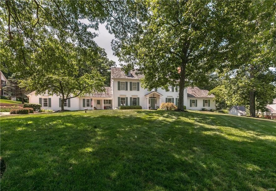 This classic, Grotpeter-built, Williamsburg colonial 1.5 story home is located in the heart of Town & Country on a beautiful 1 acre wooded lot backing to Longview Farm Park in prestigious Wheatfield Road Subdivision. As you enter this 5 bedroom, 5/2 bathroom home you are met with a grand open staircase that leads to 4 second floor bedrooms with generous room dimensions and wood flooring. The main floor features the master suite with fireplace and library, formal living & dining rooms, family room, kitchen, breakfast room, mudroom and laundry. The vaulted sun room overlooks the beautifully landscaped and lighted patio, terrace and backyard. The home also features 9 ft. ceilings, a second back staircase and 5 fireplaces. Extensive custom mill-work throughout and wide plank white oak floors enhance the charm and beauty of this home. Walkout lower level includes second family room with fireplace, game room with wet bar, full bath, workout area. Additional Rooms: Mud Room, Sun Room