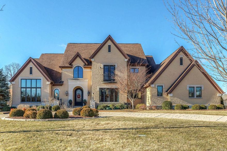 This beautifully designed 1.5 Sty Estate home features over 7800 sf of living space enhanced by soaring windows, eucalyptus hardwoods & elaborate moldings. 2-Sty marble foyer with dramatic curved staircase leads to vaulted study with built-in bookcases, elegant dining room & spectacular great room with wet bar & cast stone fireplace. State-of-the-art kitchen with quartz countertops, 42” gray cabinetry, commercial grade appliances & butler’s pantry adjoins light-filled breakfast room & hearth room highlighted by floor-to-ceiling stone fireplace. Sumptuous master bedroom suite with lavish bath with jetted tub & shower spa offers a relaxing retreat. Elevator access to 2nd floor living quarters with 3 additional bedroom suites, bonus room & 2nd laundry & Lower Level entertainment space with recreation room with fireplace & wet bar, game room, wine cellar, 5th bedroom suite & ½ bath. Grounds include outdoor living room with stone fireplace & grilling station, hot tub & pool with waterfall.