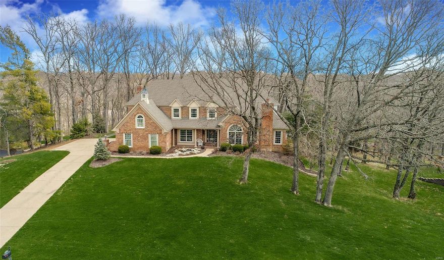 Impeccable all brick, 1.5 sty, featuring 6700+sf, situated on 1+ park-like ac, backing to woods is a dream come true! Magnificent foyer w/ T-staircase welcomes you to 2 sty, beamed great rm w/ floor to ceiling stone F/P, wet bar, palladian wndw & adjoining den w/ access to private deck. Formal dining rm accented w/ custom Italian clay ceiling, crown molding & wainscoting. French doors open to paneled study w/ 11ft ceilings & built-in bookcases. A chef’s kitchen offers granite, SS appl, 42” cabs w/ under cab lighting & brkfst bar. Octagonal vaulted brfkst rm w/ Amish wood ceiling & access to expansive patio. Main floor mstr suite w/ customized WIC & lux mst bth w/ dbl vanity & Whirlpool tub. Upstairs 3BR’s, all w/ WIC, loft & sitting area. Luxury continues in W/O LL; rec rm, state-of-the-art media rm, granite walk-behind bar w/ Viking wine cooler & ice maker + full bath. New wndws, lighting, sprinkler & sec syst, zoned HVAC, 3 car garg & landscaped to perfection! REFLECT YOUR SUCCESS!