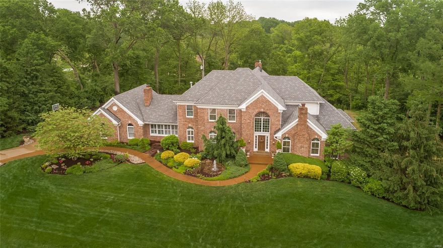 A tranquil retreat. Nestled on a private lane with Ladue Schools & 1+ acre, this stunning property features gorgeous outdoor spaces as well as over 7,300 sq ft of total living space that has been extensively renovated with the highest quality finishes. Just completed, state-of-the-art pool, hot tub & lush landscaping awaits! Move-in ready, this home blends old world charm with modern living. Grand 2 story entry opens to elegant dining room, paneled den & dramatic GR. Custom, hand-scrapped inlaid hardwood flooring & elaborate mill work. Beautiful gourmet kitchen w/ Subzero, Wolf, custom cabinets & more. Fabulous family hearth room with custom built-ins, custom ceiling beams & fireplace adjoins kitchen & opens to outdoor living. Main floor master bedroom/bath, walk-in closet & private deck. Upstairs there are 3 bedrooms & 2 full baths. Walk-out LL has family room w/ fireplace, kitchen, exercise, billiards area, office/guest bedroom, full bath. LL sqft approx. 3 car garage and much more.