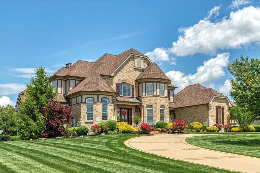 This spectacular European-inspired Estate home features over 6700 sf of living space enhanced by Brazilian pecan & oak flooring, extensive millwork, plantation shutters & custom built-ins. Impressive 2-sty foyer highlighted by dramatic curved staircase leads to vaulted study, elegant dining room & stunning great room with soaring windows, wet bar & cast stone fireplace flanked by built-in bookcases. Chef’s kitchen featuring granite countertops, 42” glazed cabinetry, commercial grade appliances, 9’ center island & butler’s pantry adjoins light-filled breakfast room & hearth room with stone fireplace. Spacious master bedroom suite with beautifully appointed bath with shower spa & jetted tub offers a relaxing retreat. Front & rear staircases access 3 additional ensuite bedrooms. Lower Level includes recreation room with fireplace & wet bar, game room, 5th bedroom suite & ½ bath. Situated on parklike 1-acre grounds with paver patio with full-height fireplace, circular drive & 3-car garage.