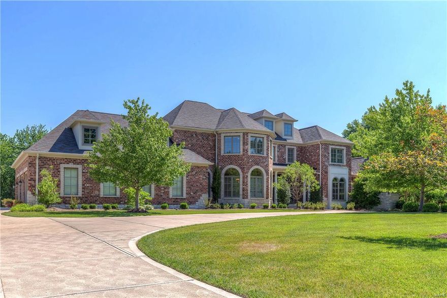 Custom-built Estate home on parklike 1-acre grounds! Homer Award-winning 1.5 Sty features over 7600 sf of living space enhanced by Brazilian cherry & marble floors, expansive windows, 10’ ceilings & extensive millwork. Extraordinary 9’ wrought iron double doors lead to 2-sty foyer with architectural columns, private study with built-in bookcases, elegant dining room & stunning great room with dramatic 2-sty bow window & granite fireplace. Exceptionally large kitchen with professional quality appliances, granite countertops & cherry cabinetry adjoins light-filled breakfast room & coffered hearth room with stone fireplace & French doors that open to deck. Sumptuous master bedroom suite with 2 walk-in closets & lavish bath with Jacuzzi & shower spa offers an appealing retreat. Front & rear staircases access 3 additional ensuite bedrooms. Incredible walk-out Lower Level includes recreation room, game room, 2nd kitchen & ½ bath. Professionally landscaped lot with deck, patio & 3-car garage.