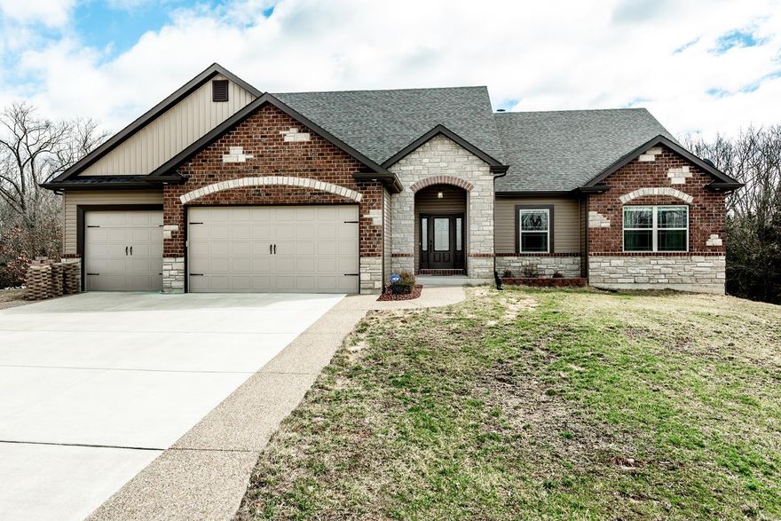 Escape to the woods in this custom built ranch with luxurious features you will love! 11' & 9' ceilings, bamboo floors, arched doorways & gorgeous wood views on the main level. Stunning finishes include a stone fireplace, double crown molding, impressive lighting, granite counters, 42" cabinets, walk-in pantry & stainless steel appliances, including a double wall oven. Private master suite with more wood views has a walk-in closet & spa-like bath with separate vanities & seated tile shower. Finished walk-out lower level with a 9' pour has a rec room, family room, & bed/bath that would make great guest or teen quarters. 3 separate rooms available to work from home, play, or be crafty. 3+ car garage w/13' bump out for a workshop or additional parking. Brand new paver patio w/firepit coming soon in the irrigated fenced yard. Composite deck. Adjoining 2 acre lot also for sale. Only 6 miles from Troy or 20 min from Wentzville, but a world away from the noise. Wooded paradise! See it today!