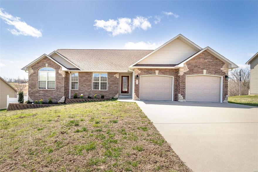 Luxury living available now! Enter this brick beauty to a foyer and living room showcasing wood-look tile floors.  The main floor offers a custom look kitchen with eat-in space providing access to the deck, with plenty of room for catching the game while at the grill. Back inside, two bedrooms, laundry room with wash sink and a full bathroom sit across the home from the master suite. The gas fireplace of the living room is a see-through to the master suite sitting area! The master includes dimensional ceiling, his and hers walk-in closets, vessel sinks, and more! Downstairs, find a rec room complete with pool table, gas fireplace and wet bar. A fourth bedroom is carpeted for comfort and located conveniently across from a full bathroom. Down the hall, find a dedicated movie room, unfinished storage & access to the fenced yard. A hot tub with privacy screen provides the perfect retreat, in this highly desired subdivision. Bullnosed corners, arched doorways and surround sound throughout!