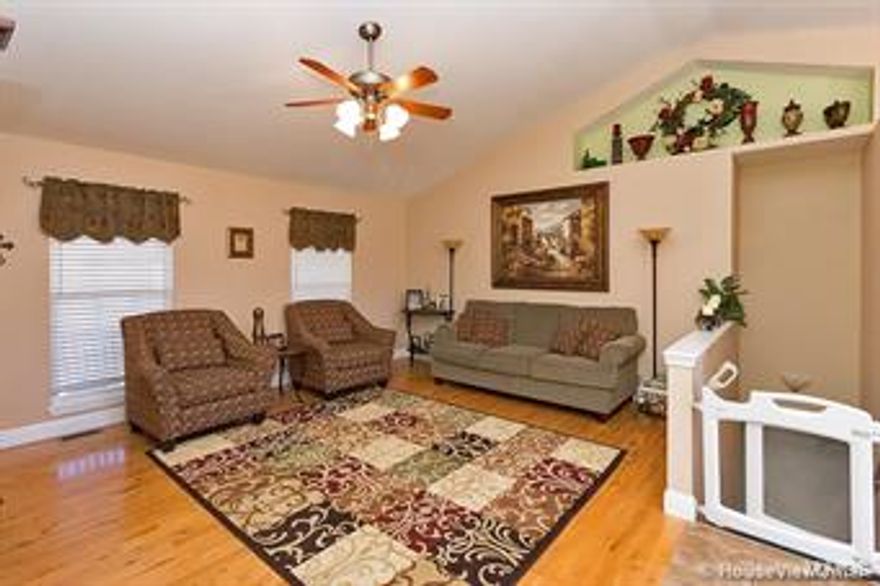 From the moment you drive up to the classic front of this beautiful home with welcoming front porch, you'll feel right at home. The living room, dining and kitchen boast vaulted ceilings with 2 showcase shelves. Extras, Extras, 3/4" hardwood flooring grace the living room, entry, hall, and extra bedroom, all 4 bedrooms have walk-in closets. Custom counter tops in the kitchen, halt bath and master bath give the home a distinctive air. The master bedroom has a tray ceiling with crown molding and master bath has a double vanity and 5' walk-in shower with dual shower heads. Entertaining is a pleasure from the expansive family room in the finished walk-out basement to the spacious 10x23 foot deck overlooking a beautifully landscaped yard. Call for your showing today! Great neighborhood and Jackson school district.