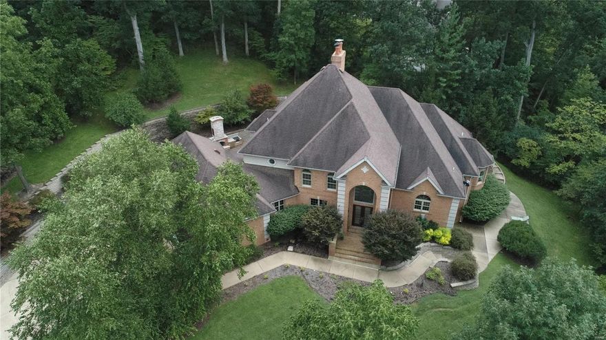 NEW PRICE! Fabulous renovations that must be seen to appreciate!  This 16 year old home has it all on 3 private acres with fresh amenities that appeal to today's buyers - main floor master, study, great room and cozy hearth room off updated kitchen with lovely patio for entertaining.  Two additional bdrms with Jack-n-Jill bath plus one ensuite bdrm on the upper with access to back staircase.  A finished walkout lower level with all the bells and whistles - fabulous bar, family room with fireplace, handsome wine cellar, fitness room, 2 full baths plus a large bonus space to fit anyone's needs.  3 acres of pure privacy surrounded by woods makes this property extremely private.  Equipped with 4 car garage with fresh floor application for the car enthusiast.  A private retreat that has been polished and updated in great taste!