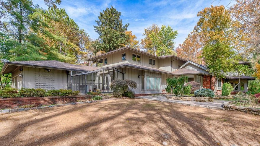 Located on over two acres of a park-like setting is this bright and open contemporary home. As you drive over the private bridge down the long driveway, you will realize that this is a special property. Located in sought-after Log Cabin Drive off of Clayton Road. The home features expansive windows that provide views of the lush plantings, pool, fountains, and waterfall. The main floor master is spacious with a spa bathroom featuring a steam shower & air tub and doors that lead to the pool area. The kitchen is gorgeous with high-end appliances, center island, breakfast room, and sitting area. The main level features a recreation room, living room, dining room, library, and an additional den. Gorgeous pool with slate terraces & hot tub. The second level features four bedrooms, each with ensuite baths, sitting room, homework room, and two balconies. Private guest suite apart from the main living area featuring a living room, dining room, bedroom, and full bath. Three car garage.