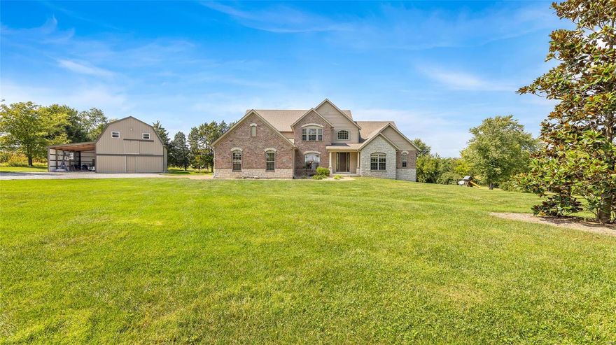 Stunning 1.5 story 5 Bedroom Home & 3 Car Garage, situated on 8.9-acres offering the perfect private living experience. As you enter, you'll be greeted by a beautiful entryway that leads to a great room boasting a ceiling-to-floor stone fireplace & custom built ins. The kitchen is a chef's dream, featuring granite countertops, backsplash, stainless steel appliances, walk-in pantry, island w/ breakfast bar, eat-in area & separate dining room. Main Level also features an executive office space & spacious master suite, large walk-in closet & separate vanities. Upstairs, you'll find two bedrooms w/ a Jack & Jill bath along w/ a 4th bedroom w/ a full private bath & large loft area. In the lower level discover a bar area, living room, add'l 5th bedroom w/ full bath & plenty of storage along w/ a walk out to a great entertaining area around the custom built fire pit. Exterior features stocked pond, pasture area & 1930's refurbished barn & solar panels that serve the entire property.