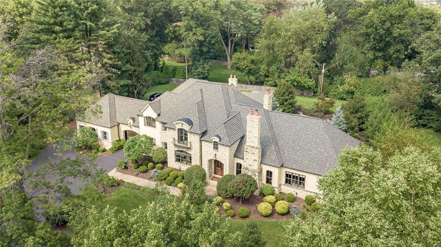Custom built Ladue estate beautifully reimagined.  Stately French facade, open plan, soaring ceilings, expansive outdoor living area all overlooking dramatic pool & water feature. This grand home impresses guests with custom oversized windows, designer lighting, expansive ceiling heights & 5" wood flooring. Open plan is an entertaining dream with Great Room, Kitchen, Hearth Room, Dining room & Den all flowing seamlessly between spaces. Opulent 1st floor master bedroom features pool access, office, spacious closet & recently enhanced spa like bathroom. 2nd floor has 3 private bedroom suites & balcony overlooking 1st floor areas. Lower level with large gathering space, impressive gym area, bath & storage. Ourdoor living space has kitchen, custom hearth, bar area, pool & unparalled privacy. Custom home with quality appointments, four car oversized garage, Porte-cochere, private gated entrance with extensive outdoor lighting, generator on private 1+ acre lot. Must see for discerning buyer. Additional Rooms: Mud Room