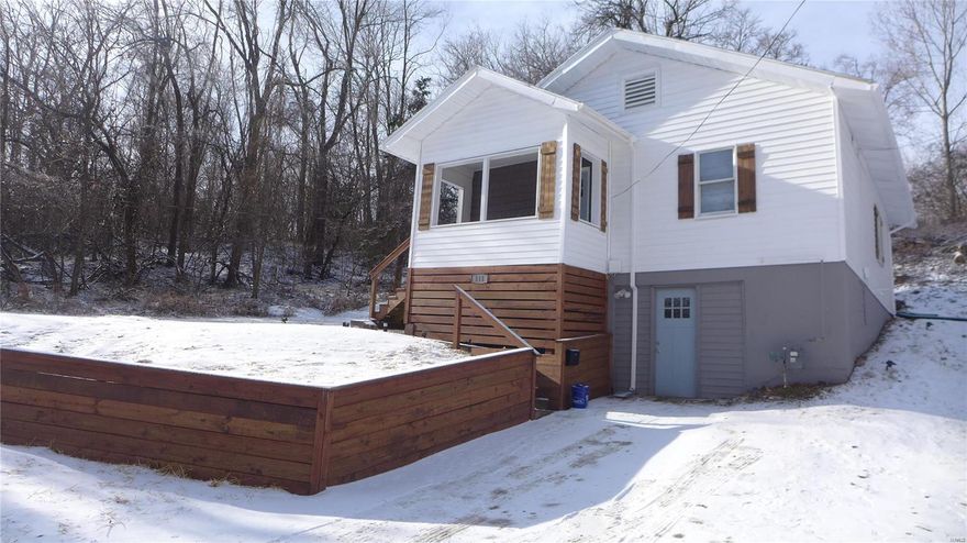 Total Remodel and Affordable Too! Seller just finished working on this cute 2-bedroom home. Mechanical systems are brand new. Spacious kitchen with new electric range and refrigerator. Plenty of cabinets and eat-in area. Bath totally remodeled. Two bedrooms with new carpet. Living room with vinyl plank flooring will provide plenty of living space. Utility area has laundry hookups and new door to access side yard. Covered front porch has new flooring and shake siding. Exterior features wood accent and wood framed retaining wall. Basement will provide lots of storage. Perfect starter home.