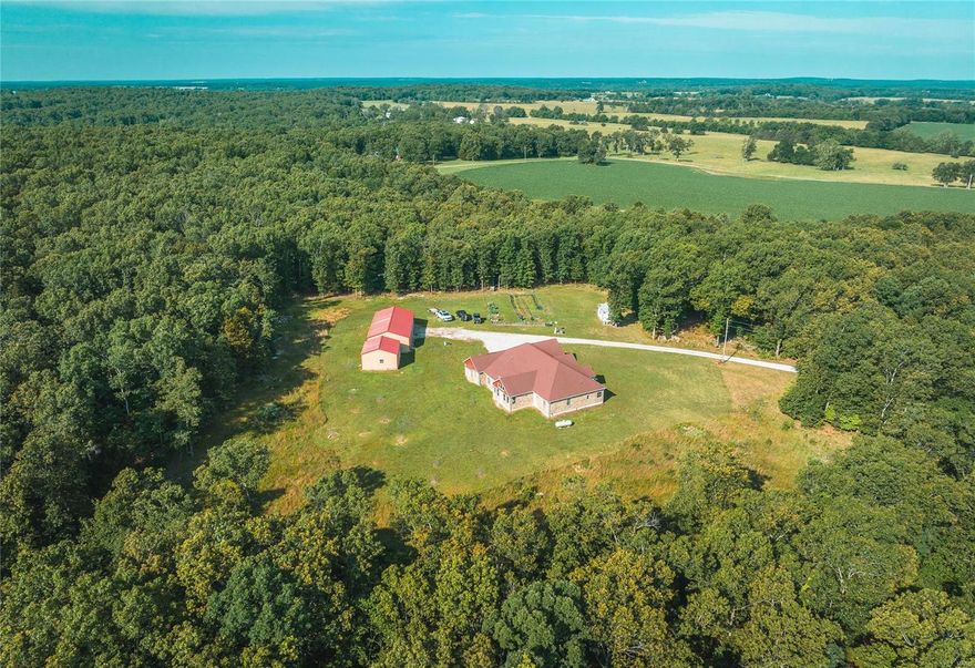 Located in Laclede County 200 m/l acres with large custom built home sits off the road on private secluded driveway. This home offers an open floor plan, large office space, luxury vinyl floors, and large master suite. A large shop building and smaller shop building on the property would make a great apartment or office workspace. Mature timber with great bedding areas and food plot locations with the 100's of acres of neighboring properties being utilized for row crop production make this property a hot spot for whitetail and turkey. Miles of side by side trails traverse through the property and lead to the over 10 acres of open pasture with stocked ponds and to the Osage Fork of the Gasconade River at the south east corner of the property. Second building spot is available at the small red hunting cabin overlooking one of the stocked ponds & could be accessed separately from the main building site through an easement off Tulsa drive.