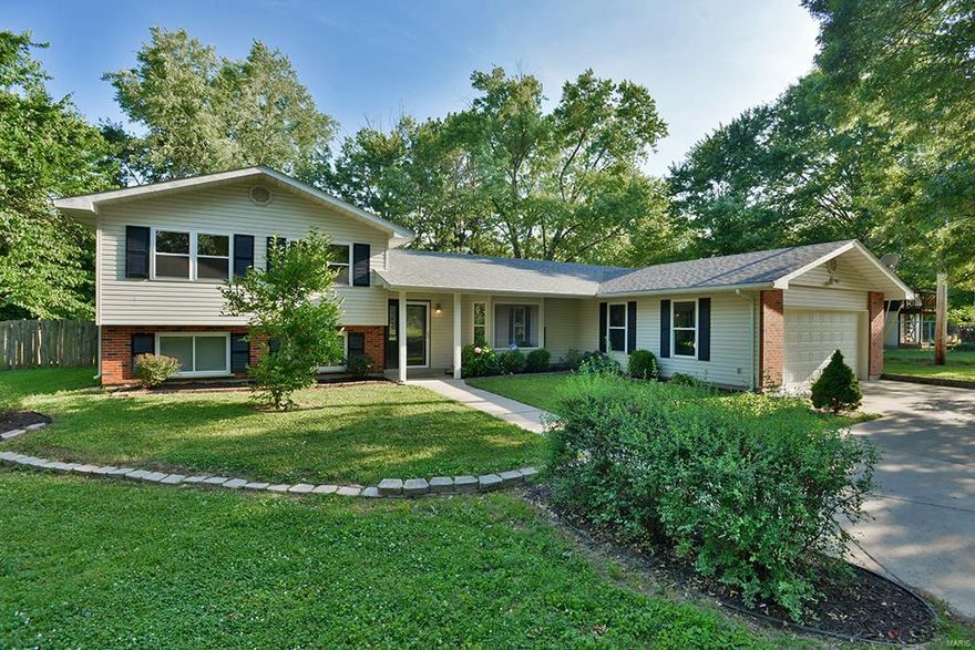 Welcome to this Ballwin Gem nested on almost an acre of level land! The location of this Tri-Level home is like none other and to have almost an acre lot in the one of the best zip codes in the country is simply a treasure! The inside boasts soaring vaulted ceilings in the open floor plan along with cherry wood kitchen cabinets, tile counter top and stainless steel appliances! The home features laminate flooring throughout and leads to a raised Master Bedroom Suite! The suite features vaulted ceilings, a beautiful walk-in closet with a shelving system, and a gorgeous on suite bath with high ceilings, his/her double sinks and separate tub! The diverse and open basement family room can be utilized for multiple functions whether it's a play room, game room, or a relaxation area. The very large, flat, and fenced backyard will surely fulfill just about any home outdoor activity or sport that comes to mind! Be the go to house for fun and entertainment and live the dream!!
